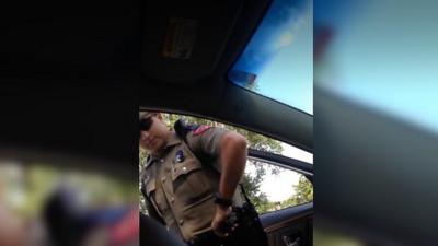 Police officer at opened car door