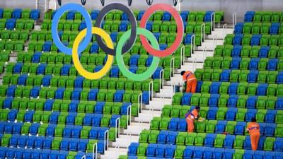 Olympic rings hanging over a seating area