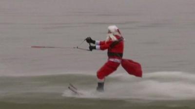 'Santa Claus' water skis at an event on the Potomac River in Old Town Alexandria, Virginia