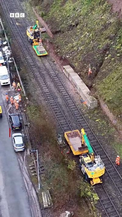 Diggers on a railway line repairing a landslip