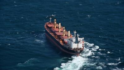 Container ship being boarded by armed forces