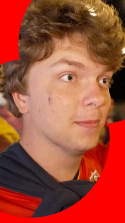 Man with light brown hair dressed in Belgium team colours