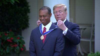 Tiger Woods receiving medal from Trump