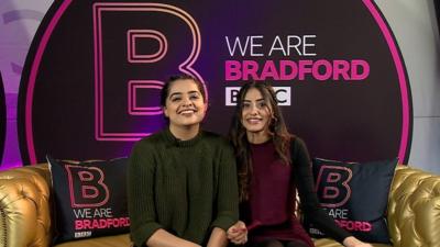 Two people from Bradford sitting on a sofa