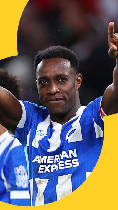 Danny Welbeck celebrates a goal with both arms in the air