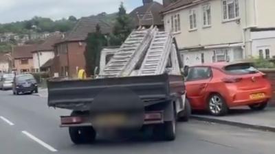 A truck crashed into a red car