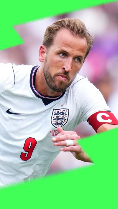Harry Kane, in England kit with captain's armband, running after the ball on the pitch