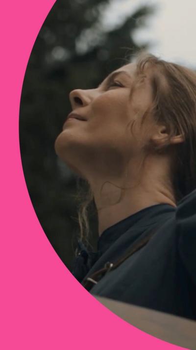 Woman outdoors looks skywards