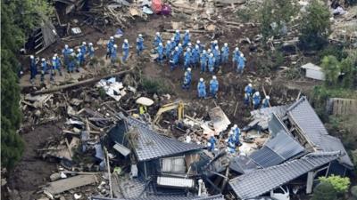 Rescue workers conduct a search and rescue operation following a landslide in Minamiaso, Japan