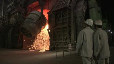 Two steel workers inside a Caparo steel works