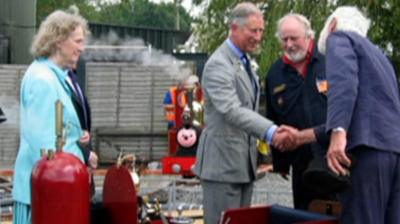 King Charles shaking hands with one of the railway team