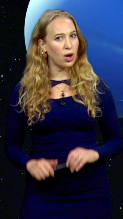 Sophia Herod standing in front of an image of Neptune