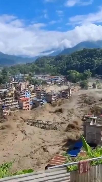 Muddy floodwaters take bridge down