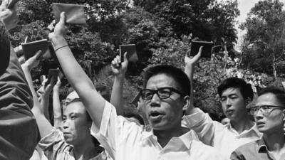 A mob shouting Communist slogans