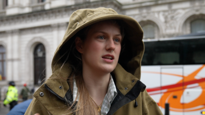 Woman in hooded coat at farmer protest in Westminster