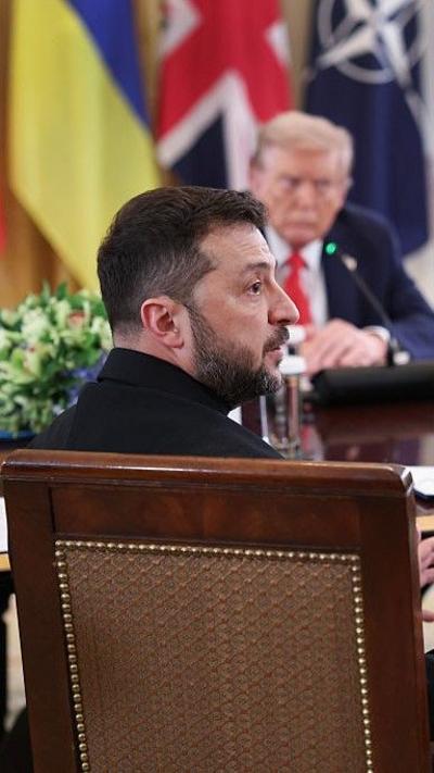 Zelensky sat in a chair in front of Trump, looking to the right hand side