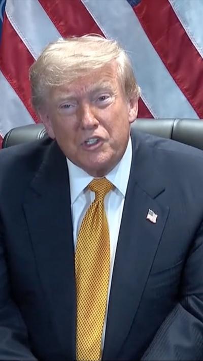 Donald Trump in a blue suit and yellow tie