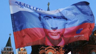 A Russian flag showing President Putin's face