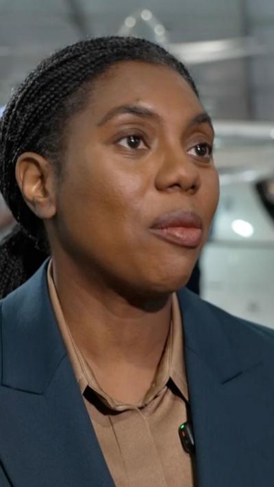 Kemi Badenoch in a brown shirt and grey jacket