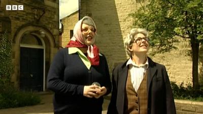 Two people dressed up as characters from The League of Gentlemen