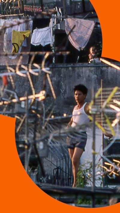 A young resident stands atop one of the Walled City's many rooftops