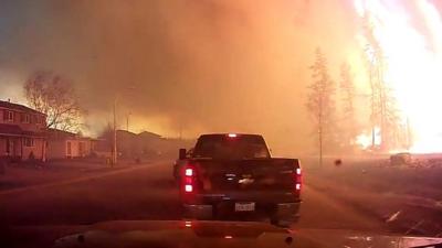 Truck driving through Alberta wildfire