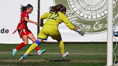 Wales defender Ffion Morgan says she and her family are 'buzzing' after scoring her first international goal.