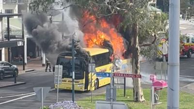 Flames and smoking billowing as from school bus