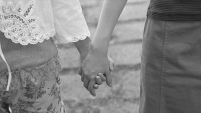 close up image of women holding each others hands