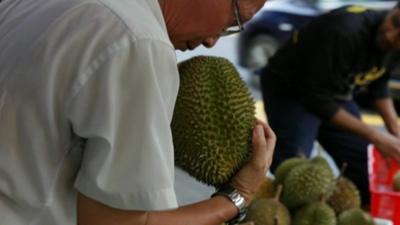 Man holds durian