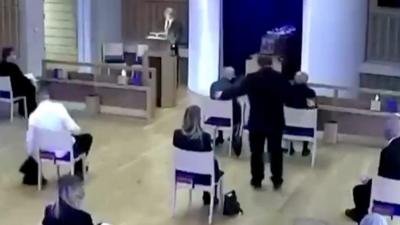 Man interrupting funeral