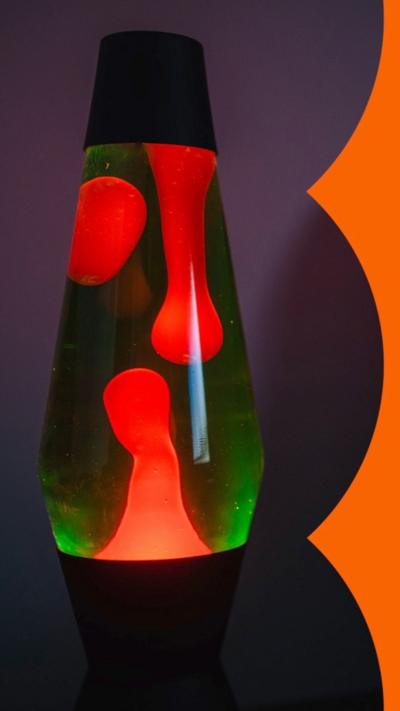 A green and red lava lamp against a purple background.