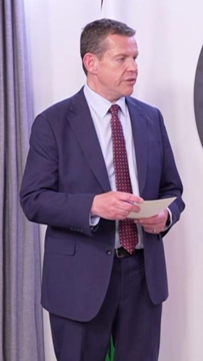 Rhun ap Iorwerth wearing a blue suit and burgundy tie
