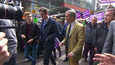 Luke Holland (left) and Nigel Farage (right)