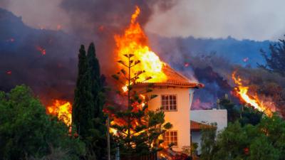 Lava burns a house in La Palma