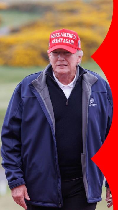 Trump wearing a red 'Make America Great Again' hat