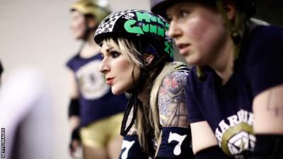 Roller Derby player watching from sidelines