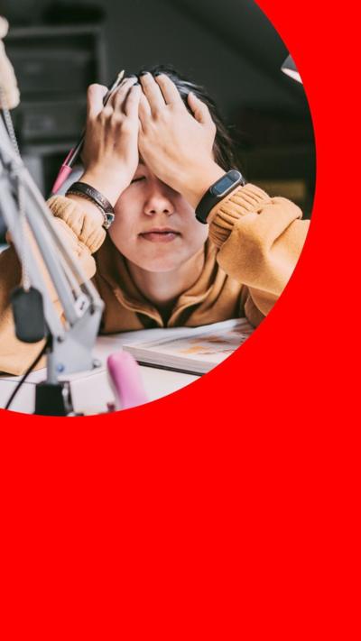 Student with head in hands while studying