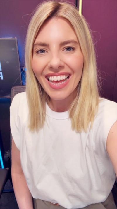 Mollie King wears a white tshirt and smiles