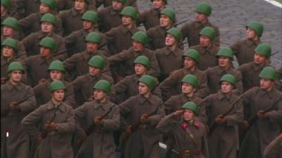 Uniformed troops march in unison