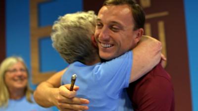 Mark Noble hugs a fan