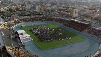 Picture showing people in stadium for Pope mass