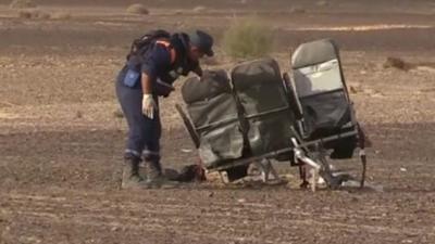 An investigator looking through the wreckage