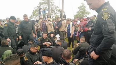 Colombian police officers in uniform sitting on the floor