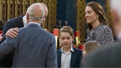 King Charles greets William, standing next to George, Charlotte and Kate