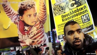 Migrants protest during a rally on 18 December in Athens, Greece