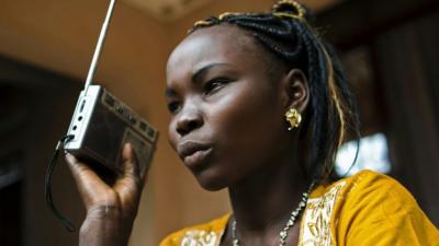 An athlete in South Sudan listening to the radio, March 2016