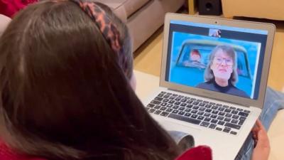 Grandmother Annette reads over a video call