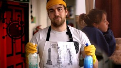 Man with cleaning bottles