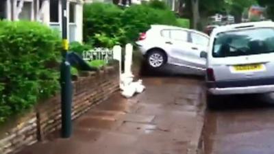 A car lifted from the road during the flood